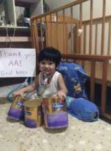 Child at PSOD with nutrition supplements from AAI
