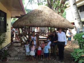 Families stay in bamboo huts outside House of Hope