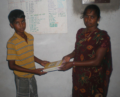 One student receiving books