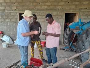 Dick and Dieu Donne working on the tractor
