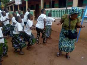 Rosalie and the children perform a welcome dance
