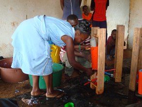 Woman learning how to use a briquette press