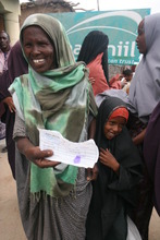 An excited family receives a voucher for food.