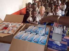 Gertride, with classmates, awaits distribution