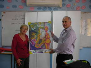 Hani and school head master holding CHEN's poster