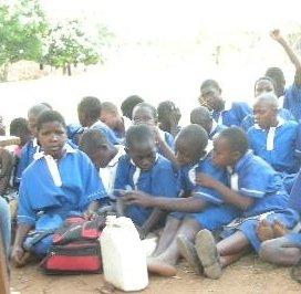 Students study outside by class led by volunteers