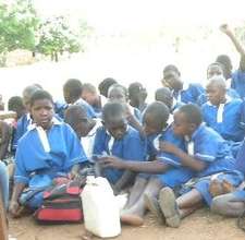 Students study outside by class led by volunteers