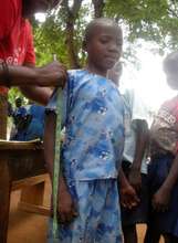 Local tailor takes measurements for school uniform