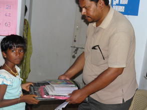 HEARDS Chairman distributing books to children