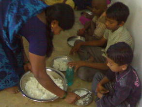 Cook serving midday meal at Prashant Nagar Colony