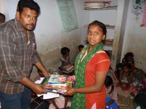 Providing bag and books for a girl child