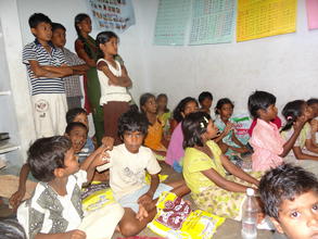 children interacting with teacher