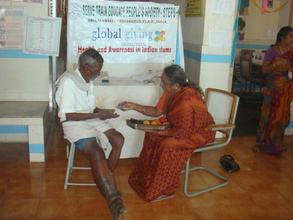 Explaining about medicines to Filariasis patient