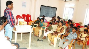 Children watch as CRS Director speaks