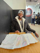 Lydell with his collection of poems with feedback