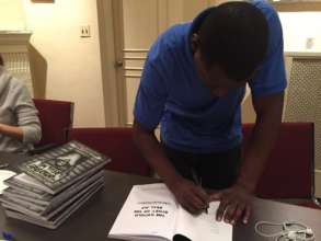 Free Minds member Michael signs journals