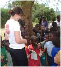 Jane Rumball greeting children at Nakivale camp