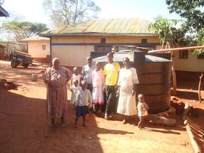 Mukita Nyolo and family with new rainwater cistern