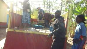 Farmers loading seedlings to a lorry