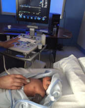 Cardiologist Dr. Guerra examines a baby patient