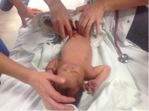 Skilled hands examine the little patient
