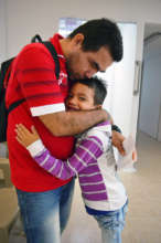 Matias hugs his father.