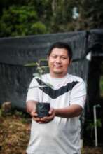 Pak Arifin and one of his tree seedlings