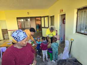 Children smiling with our volunteers