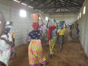 Women carring stones, sand, cement and water.