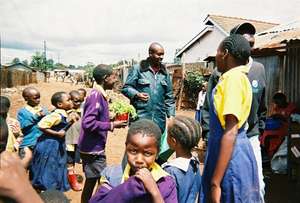 MCC Kawangware Director Pius Likami with students