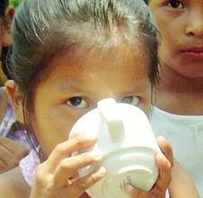 School girl takes first drink from new tank.