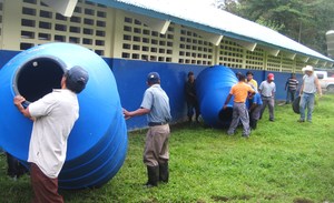 School fathers help install rain catchment tanks