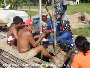 Pulili locals installing submersible water pump