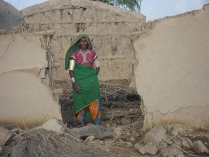 Women showing her house broken during rain floods