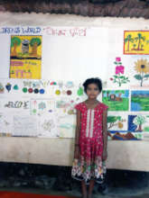 Tulasi standing with her Art works