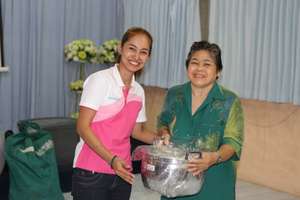 Grandmother receiving her price: a new pan