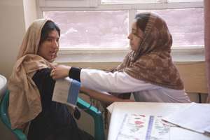 Doctor treating adolescent girl