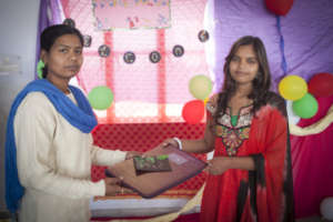 Maya(12th Grade) receiving prize from her teacher