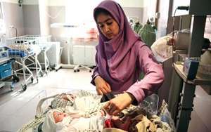 Tayibe Shafiq cares for a newborn