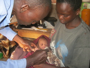 CHW checking a baby's temperature