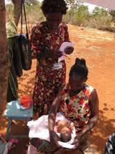 Salina checking a newborn on a home visit