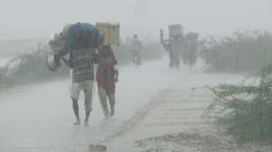 Villagers carrying their belongings