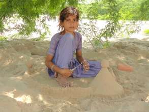 A child playing in the mud