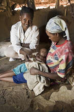 Healthcare Worker with a Happy Mother & Child