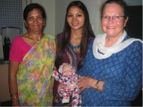 Staff with training baby for umbilical cord care