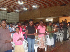 Participants light candles