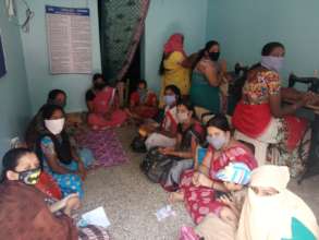Women stitching masks in early March