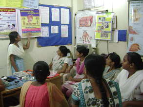 Girls attend a heath education class.
