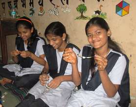 Girls learn to make ornaments from paper
