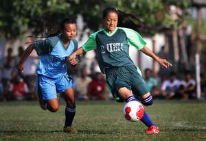 Girls in action at the Because I am a Girl Cup
